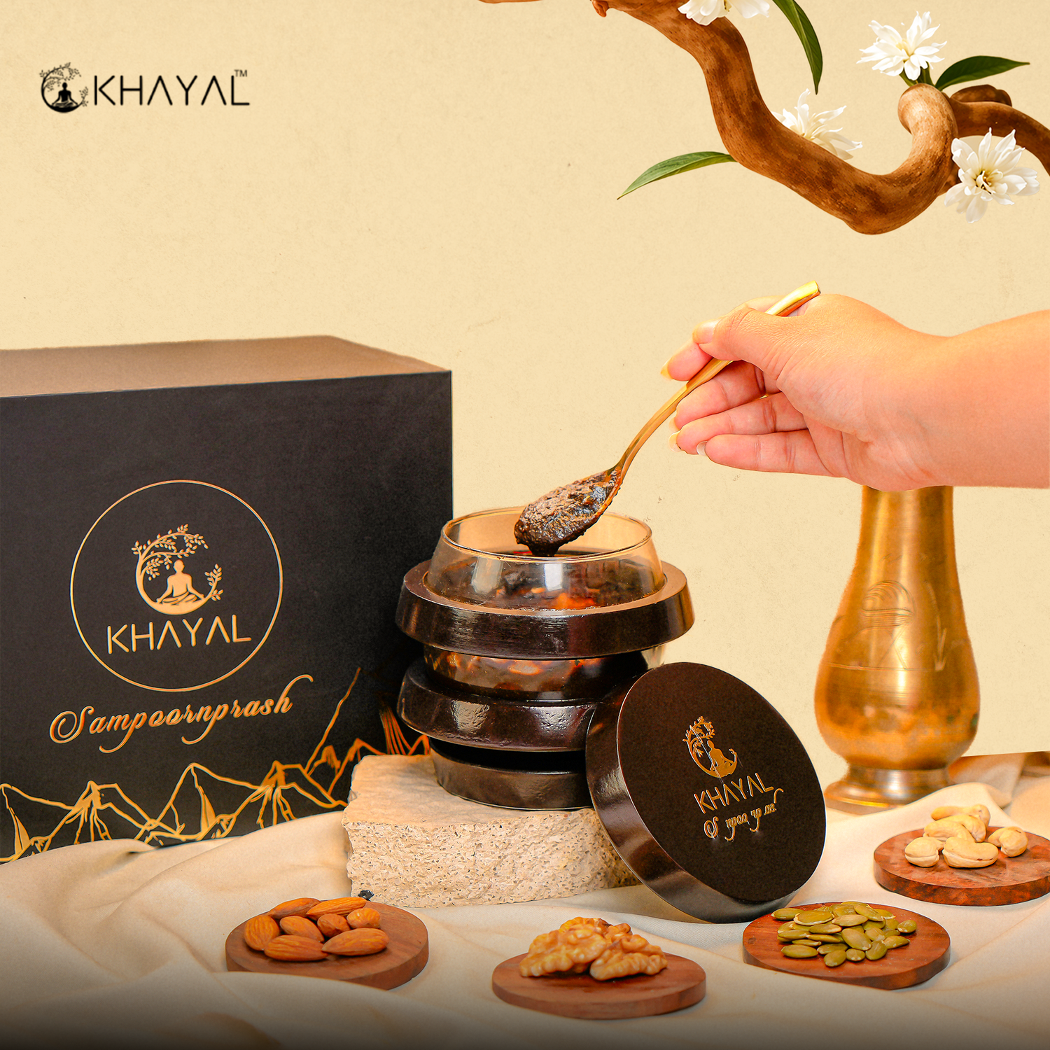 A hand scoops dark paste from a glass jar labeled Khayal Samposhprash with a gold spoon.